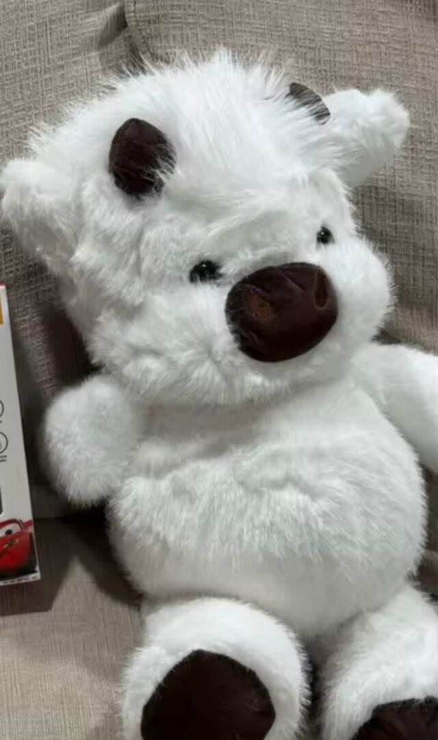 Chubby Highland Cow Plushie in cozy bedroom