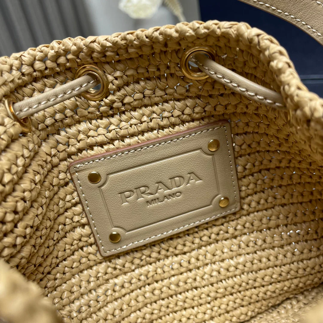 Prada  BUCKET BAG 20 IN BEIGE WOVEN RAFFIA EMBOSSED LOGO