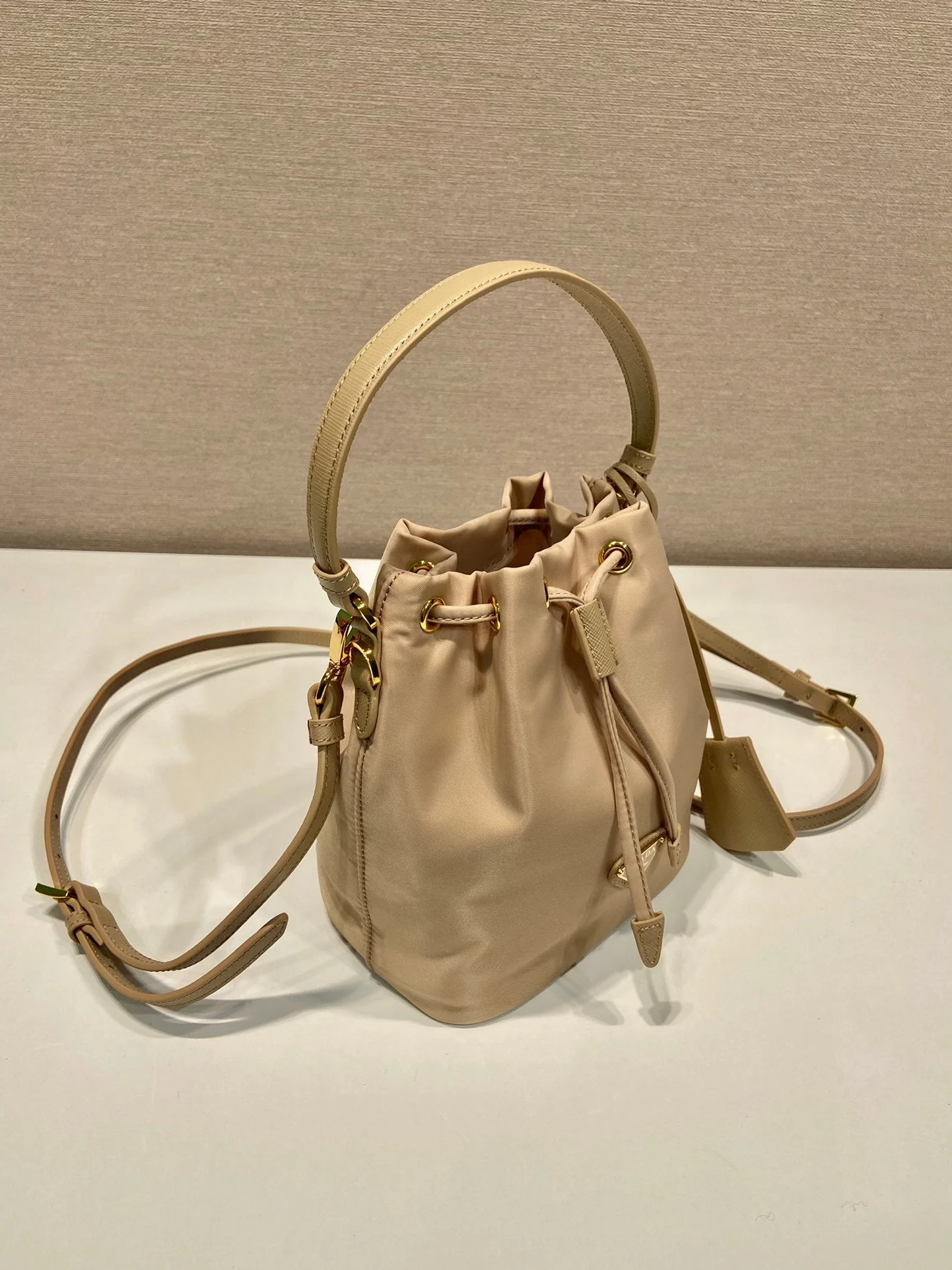 Prada BUCKET BAG 19 IN BEIGE RE-NYLON AND SAFFIANO LEATHER HANDLE