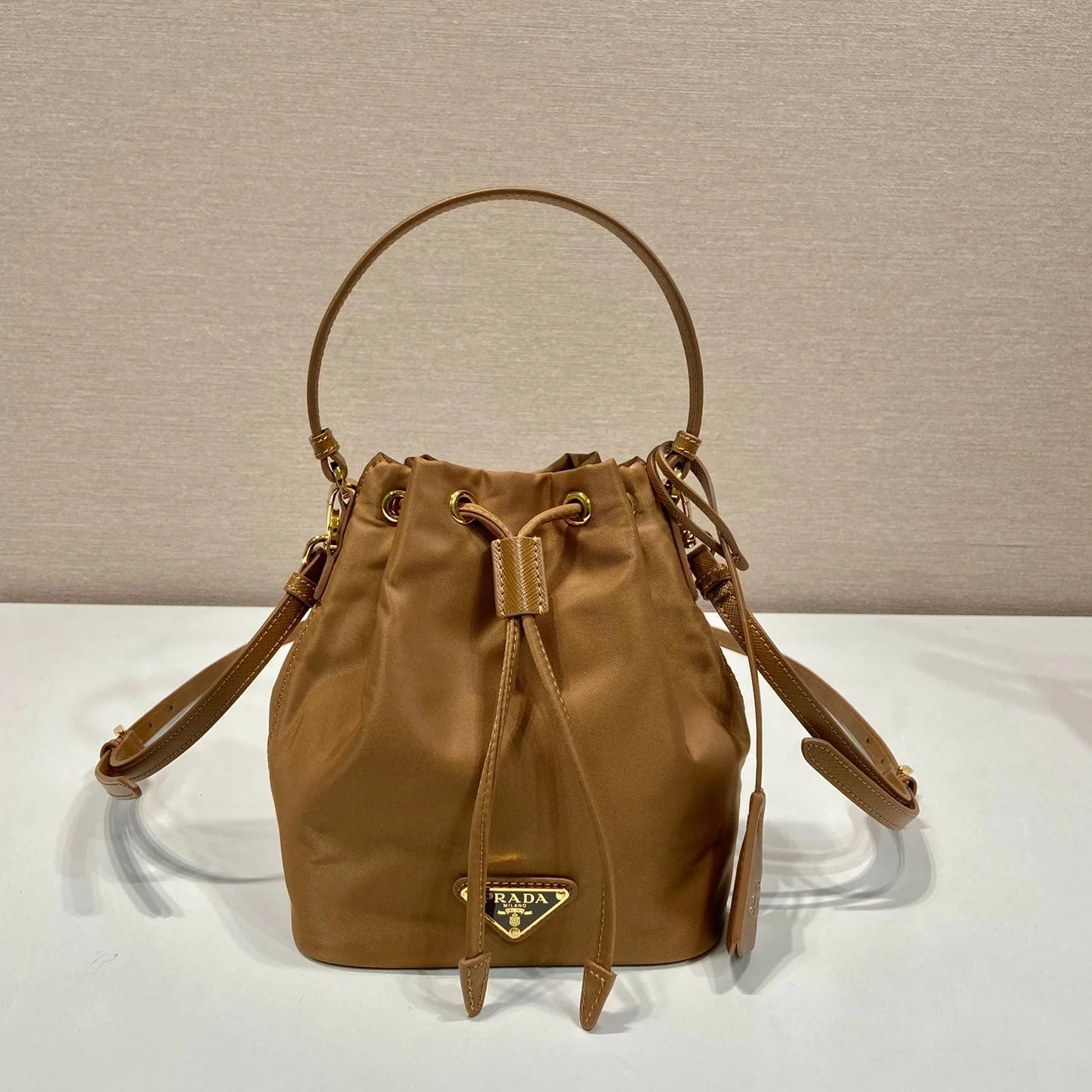 Prada BUCKET BAG 19 IN RUSSET BROWN RE-NYLON AND CALFSKIN HANDLE