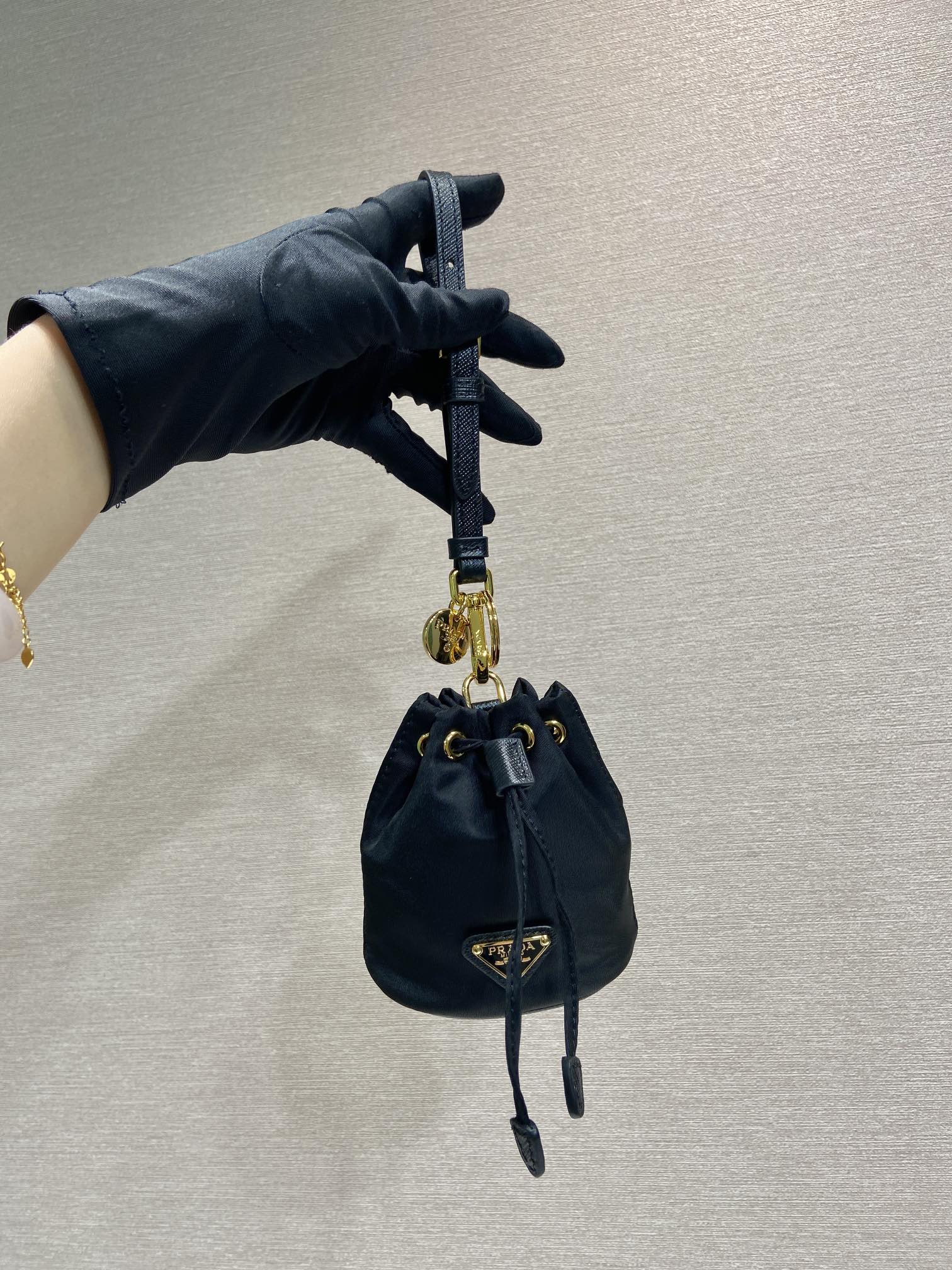 Prada MINI BUCKET BAG 10 IN BLACK RE-NYLON AND SAFFIANO LEATHER STRAP