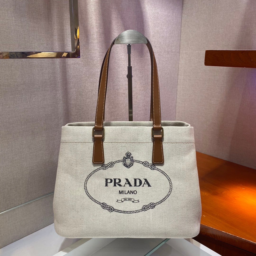 Prada TOTE BAG 33 IN WHITE CANVAS AND BROWN CALFSKIN HANDLE
