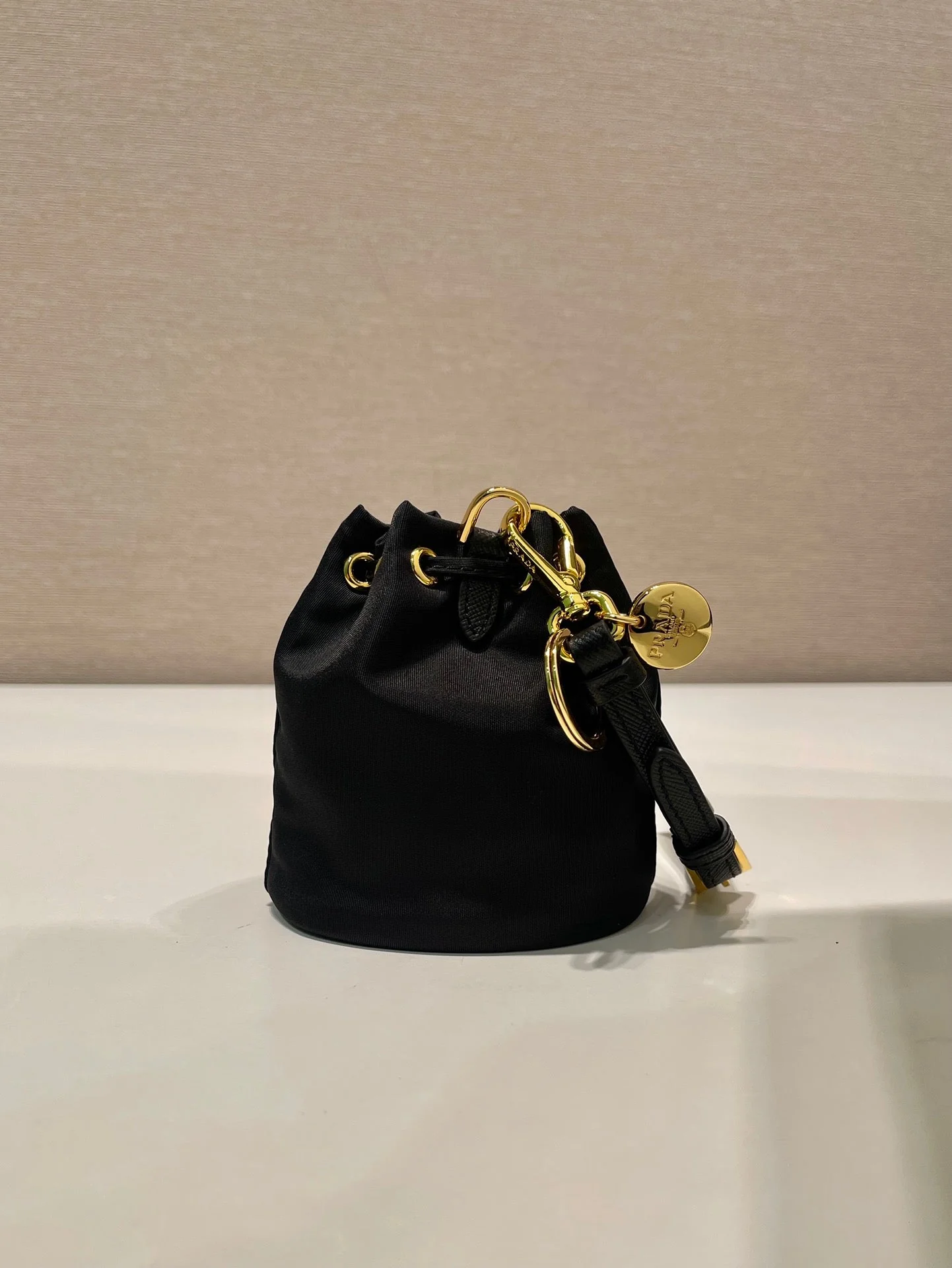 Prada MINI BUCKET BAG 10 IN BLACK RE-NYLON AND SAFFIANO LEATHER STRAP