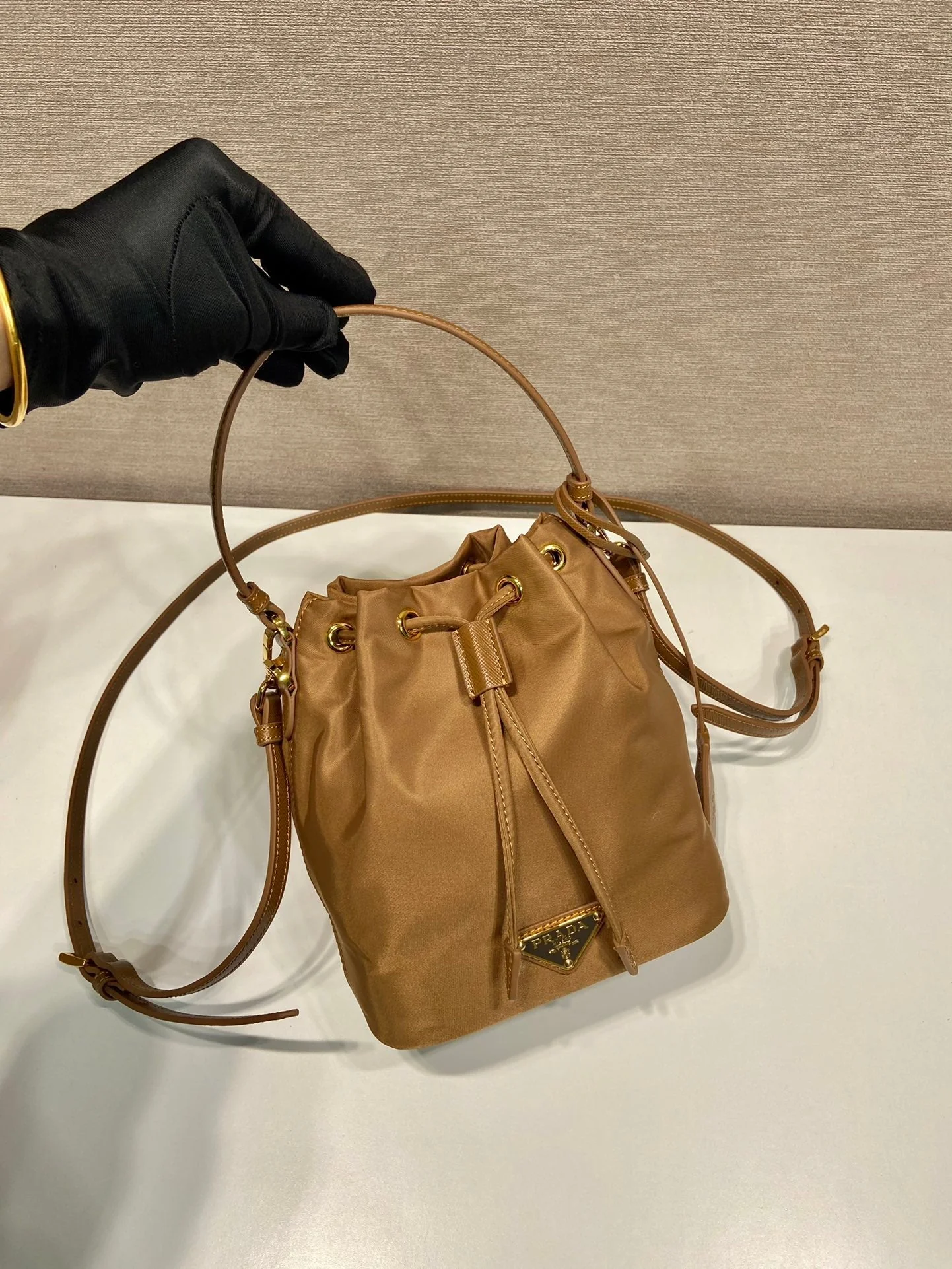 Prada BUCKET BAG 19 IN RUSSET BROWN RE-NYLON AND CALFSKIN HANDLE