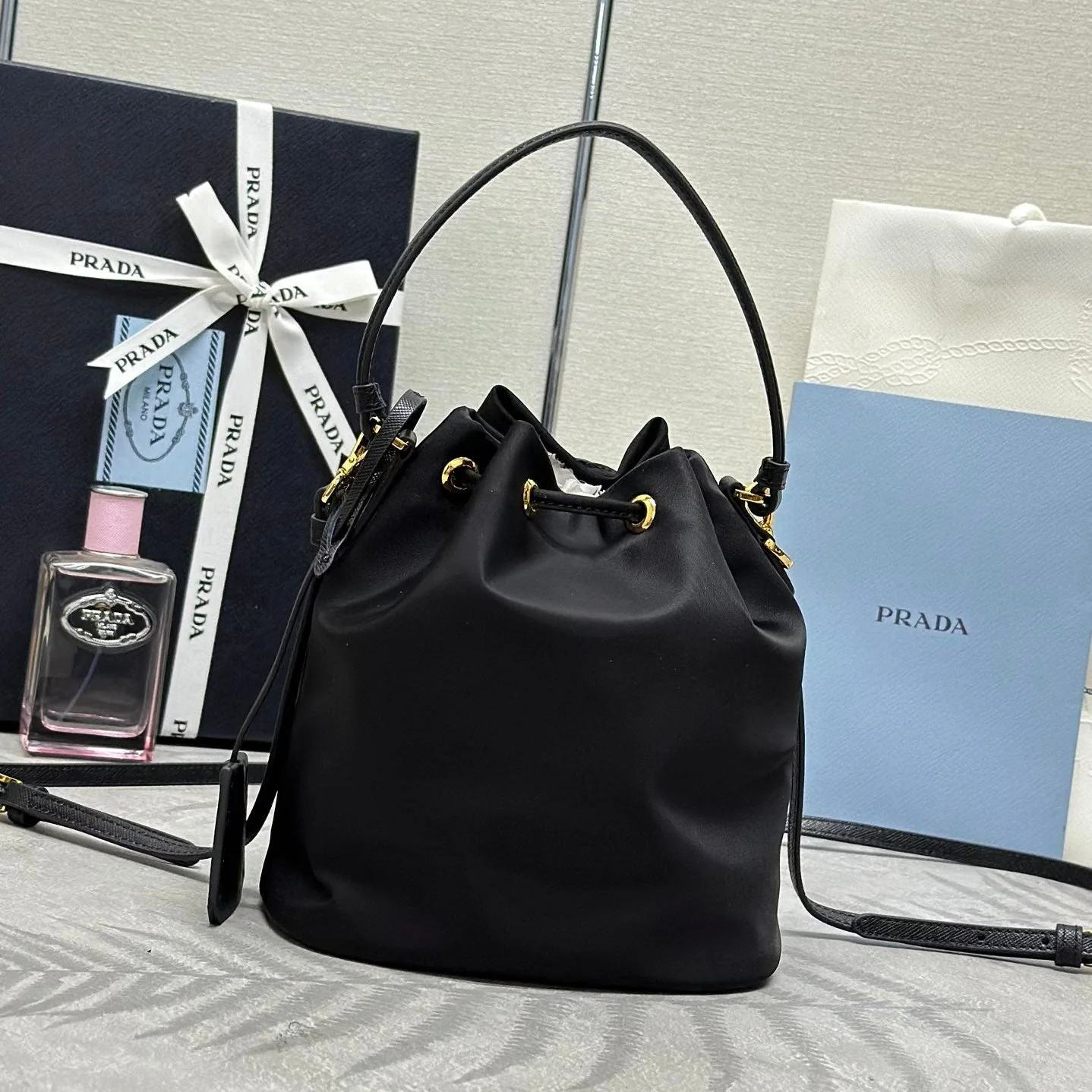 Prada BUCKET BAG 19 IN BLACK RE-NYLON AND CALFSKIN HANDLE