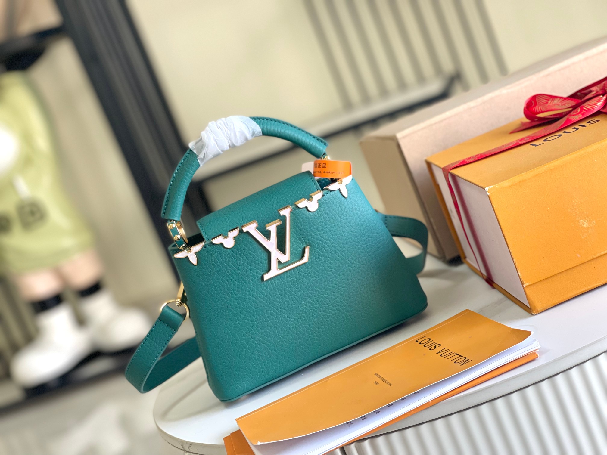 M25398  Capucines Mini in Emeraude Taurillon leather