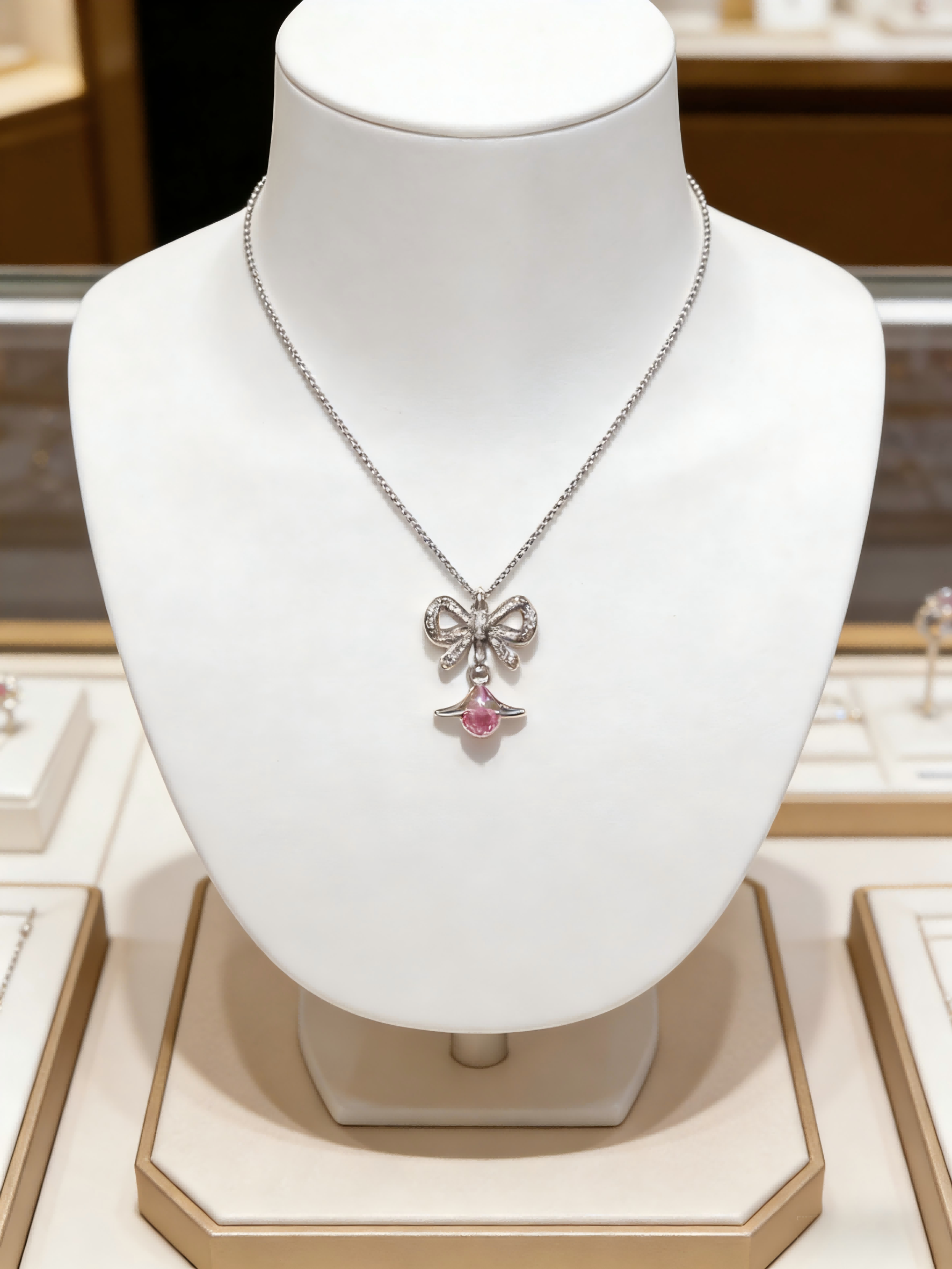 Dainty Silver Bow Saturn Pendant Necklace – Sparkling Pink Accent Jewelry Gift for Her