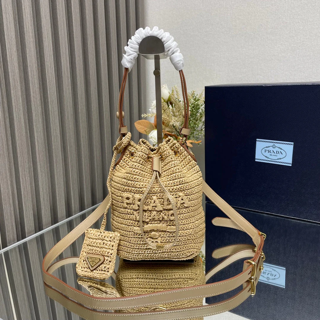 Prada  BUCKET BAG 20 IN BEIGE WOVEN RAFFIA EMBOSSED LOGO