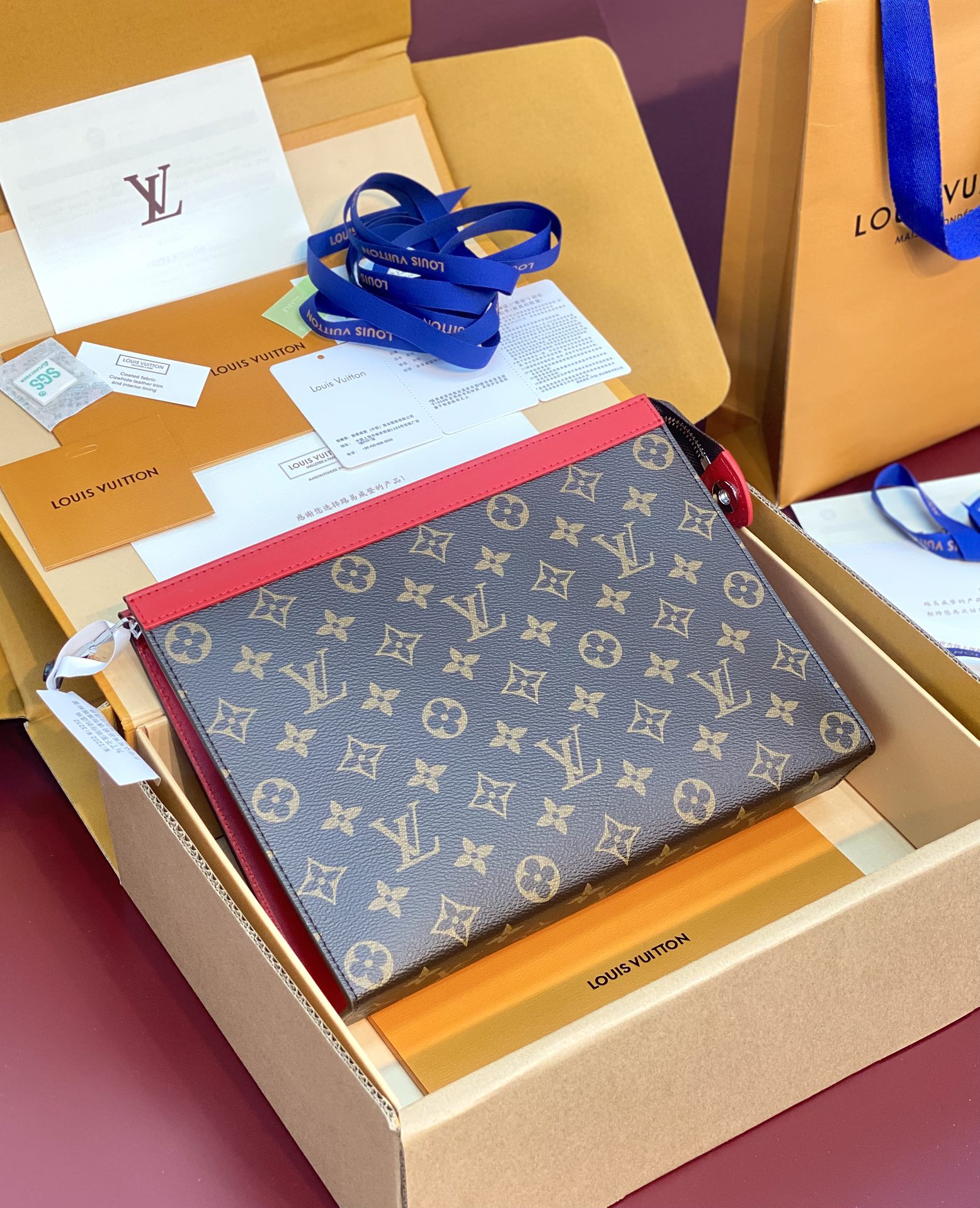 M12817 Pochette Voyage MM in Sari Red Monogram Macassar coated canvas