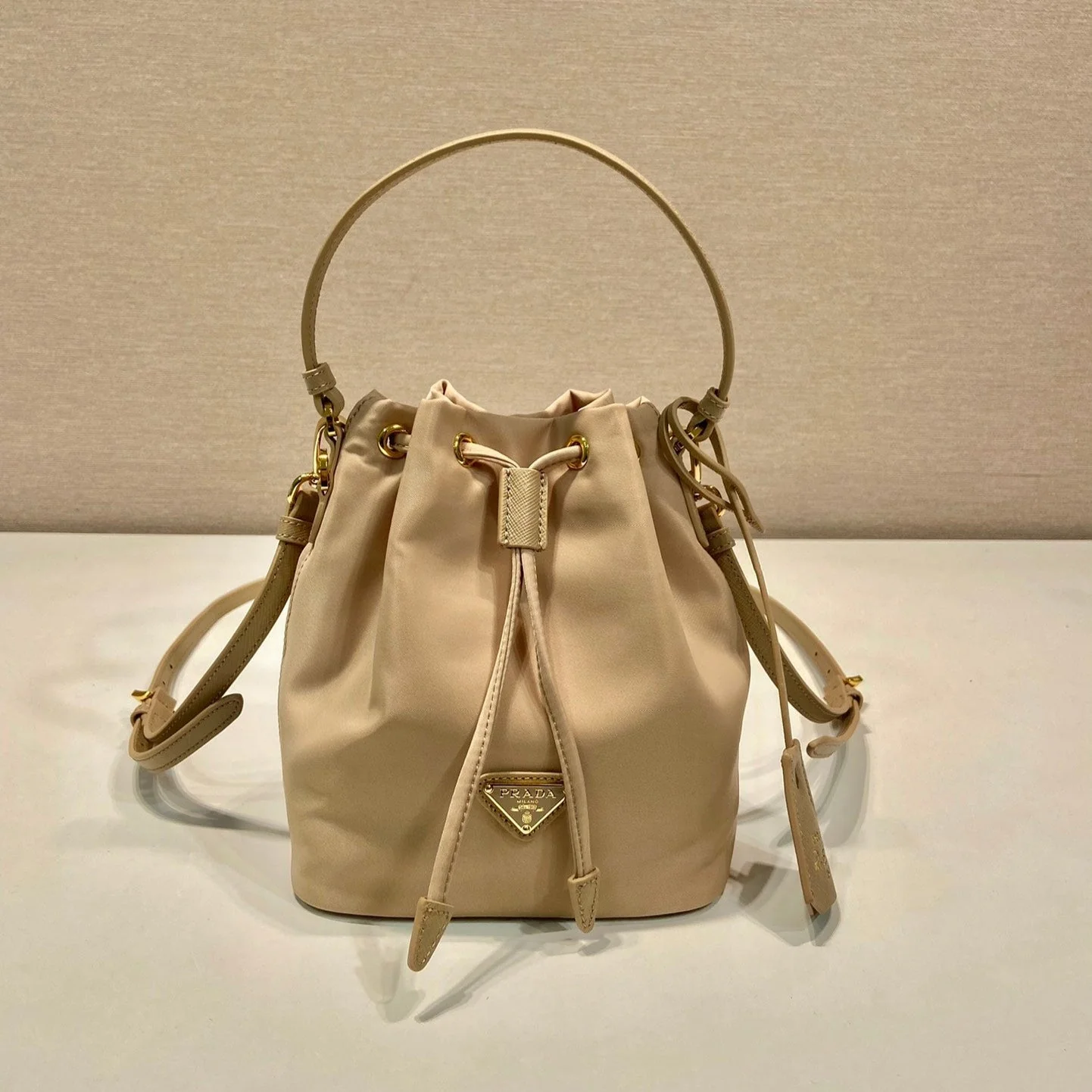 Prada BUCKET BAG 19 IN BEIGE RE-NYLON AND SAFFIANO LEATHER HANDLE