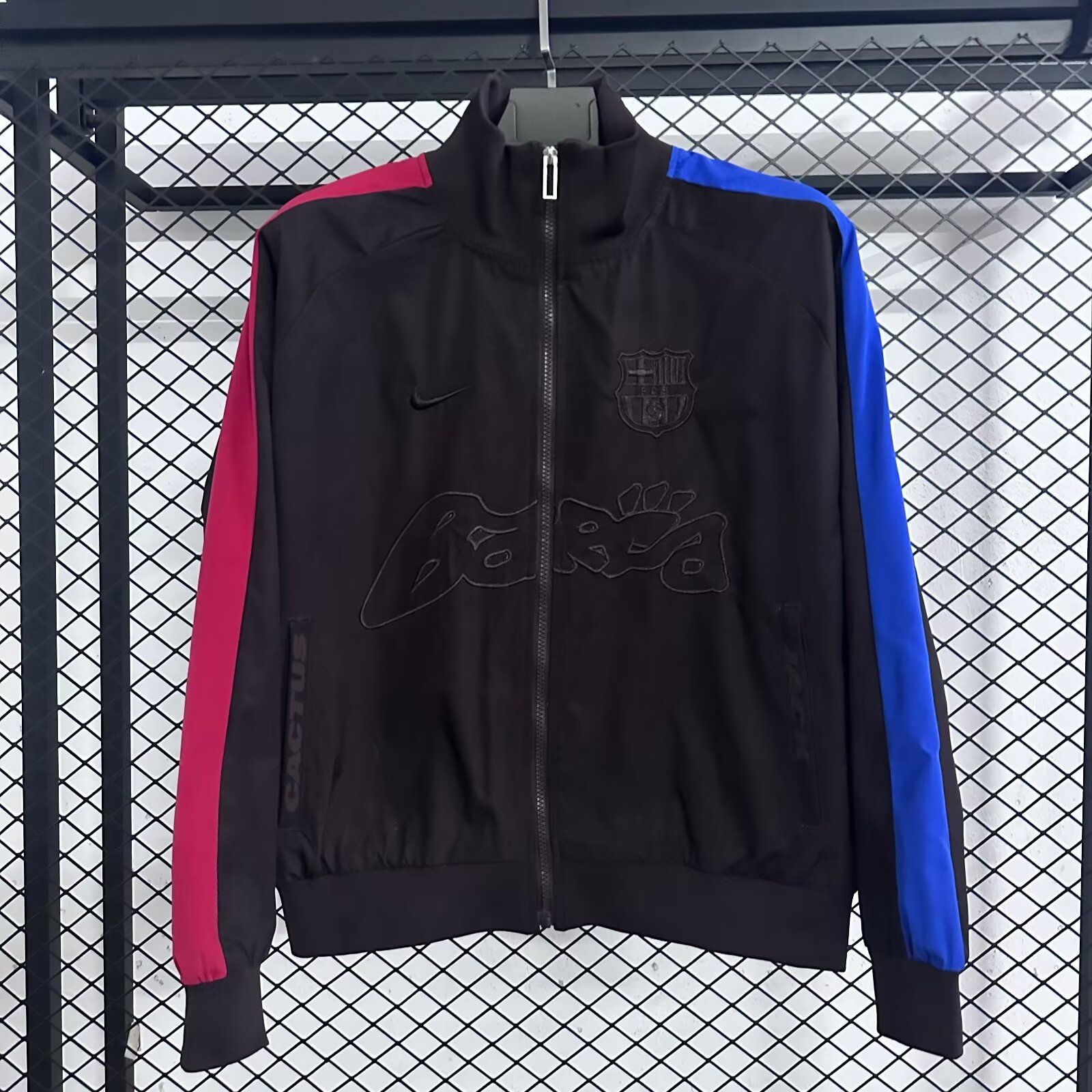 Barcelona x Nike collaboration SS25 waterproof jacket/windbreaker with embroidered logo on the chest and contrasting zip-up sleeves.