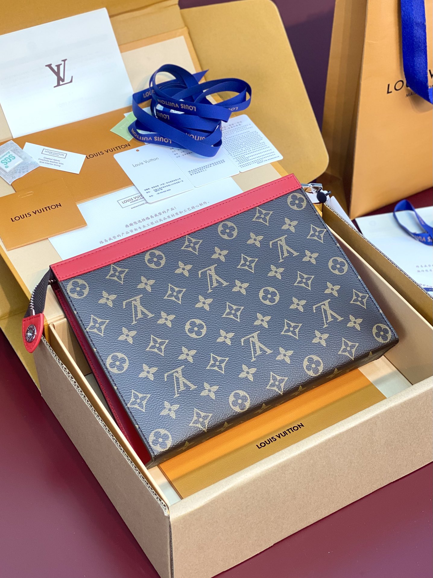 M12817 Pochette Voyage MM in Sari Red Monogram Macassar coated canvas