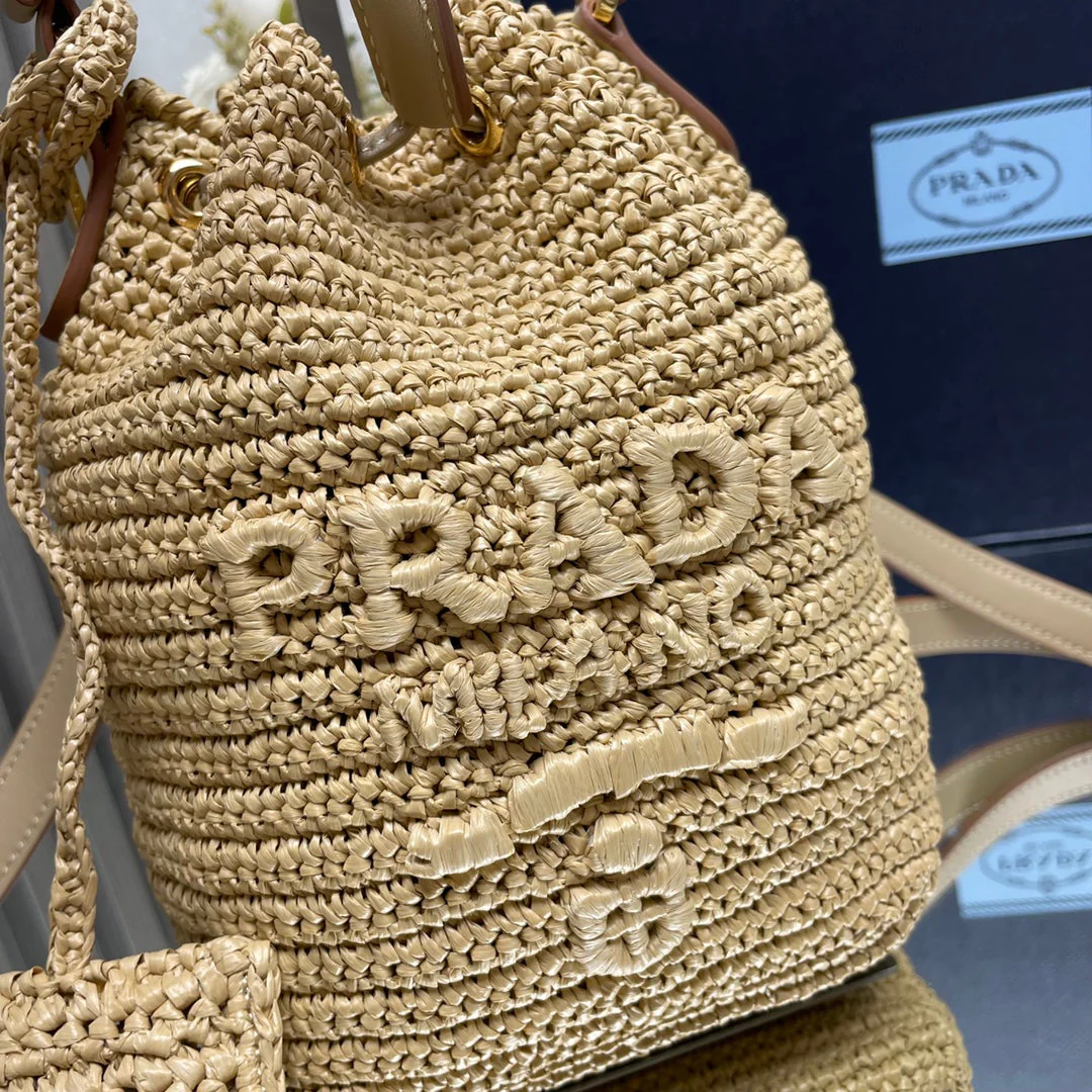 Prada  BUCKET BAG 20 IN BEIGE WOVEN RAFFIA EMBOSSED LOGO