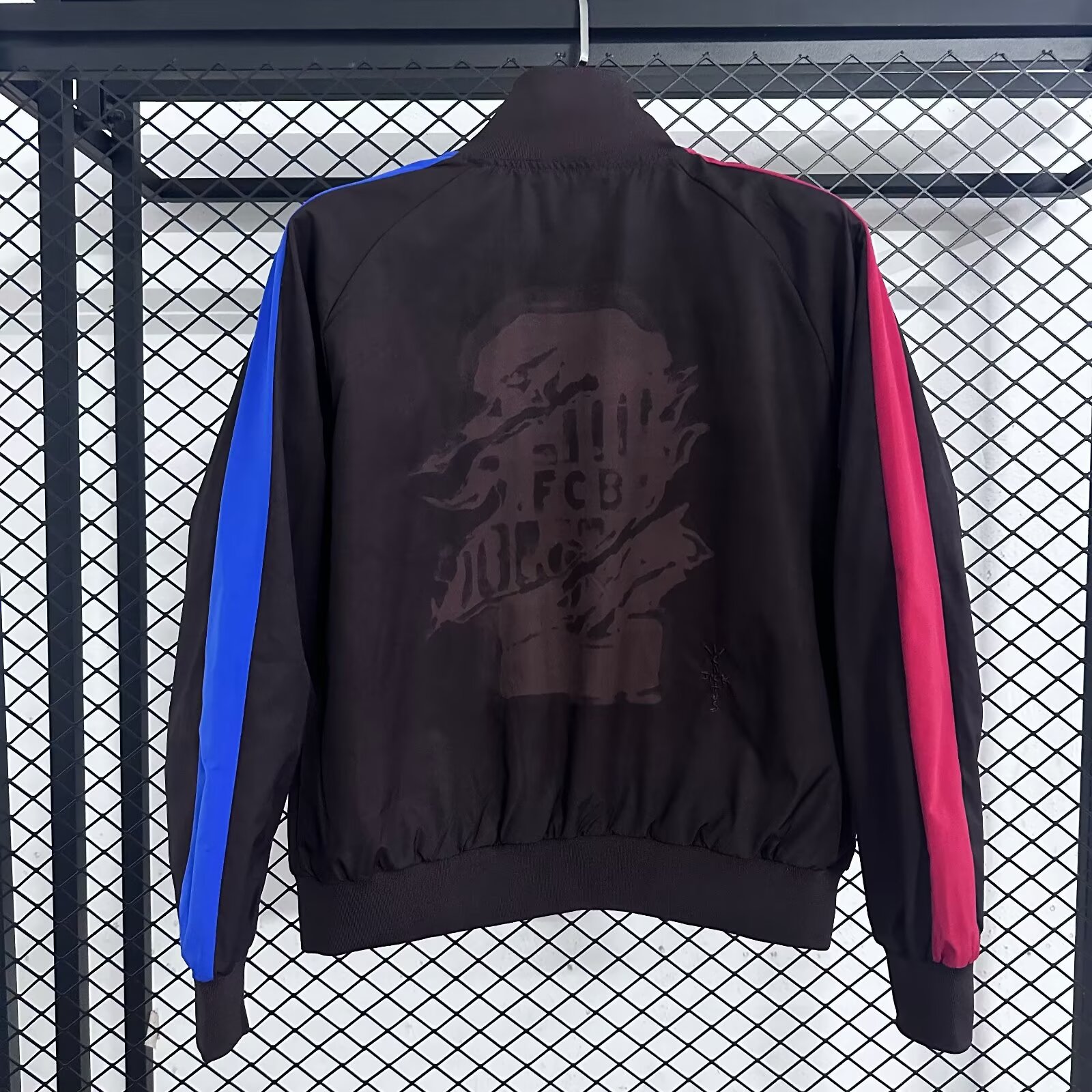 Barcelona x Nike collaboration SS25 waterproof jacket/windbreaker with embroidered logo on the chest and contrasting zip-up sleeves.
