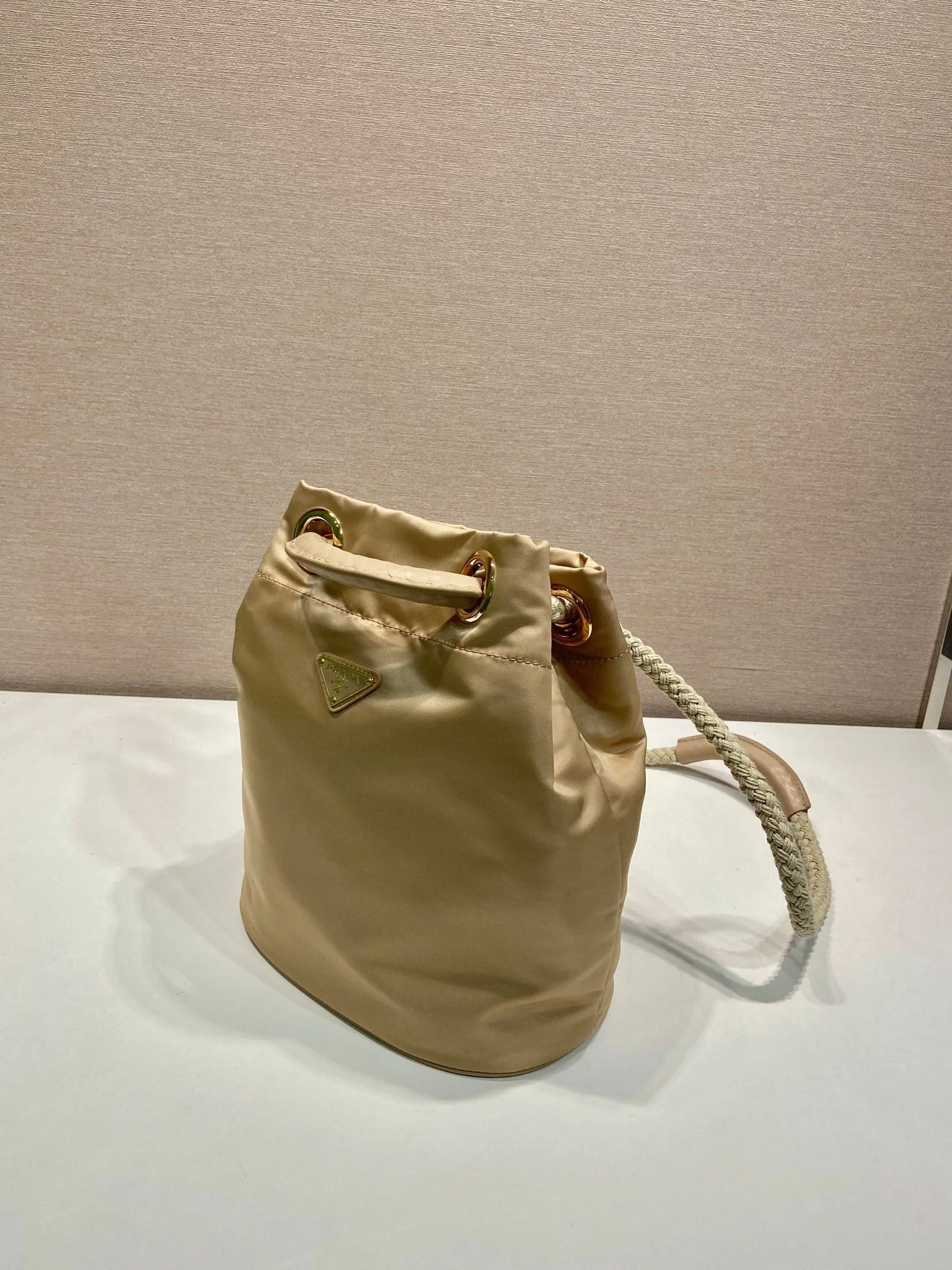 Prada BUCKET BAG 28 IN BEIGE RE-NYLON GOLD LOGO