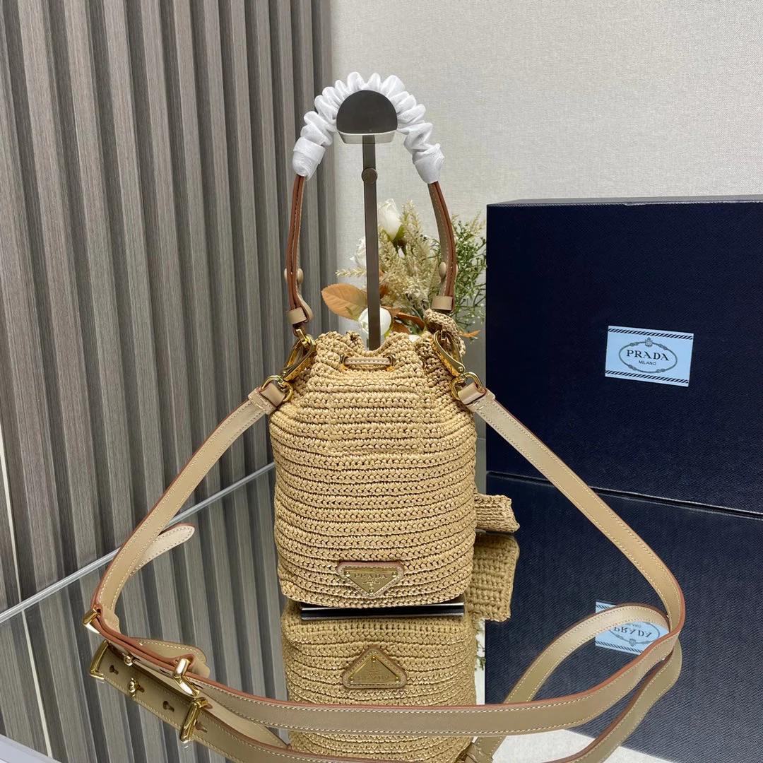 Prada  BUCKET BAG 20 IN BEIGE WOVEN RAFFIA EMBOSSED LOGO