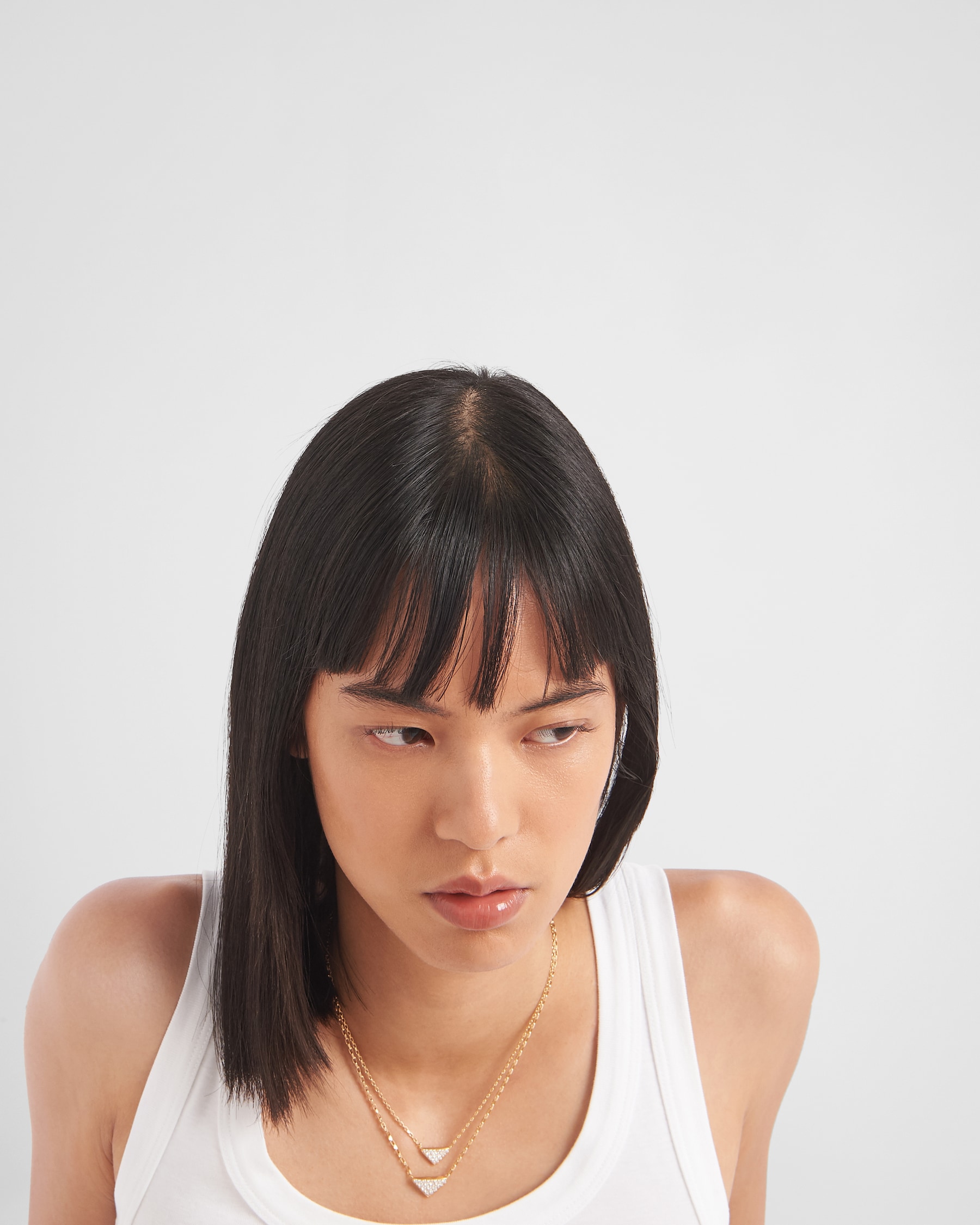 Prada Eternal Gold Eternal mini triangle pendant necklace in yellow gold and diamonds